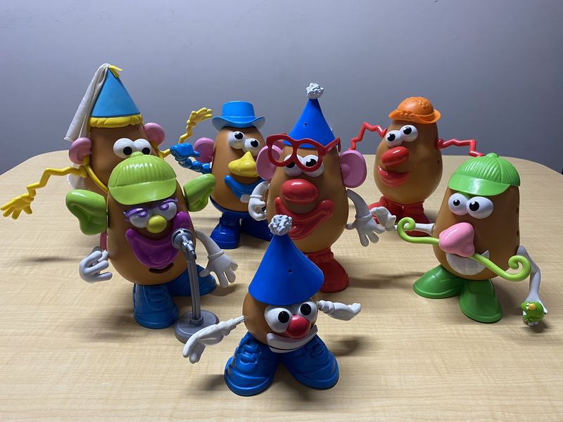 A family of Mr Potato Head toys set out on a table